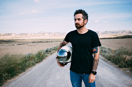 Man with vintage motorcycle helmet containing man, retro, and background, a Person Photo by DeRepente