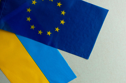 European union and Ukraine two folded silk flags together
