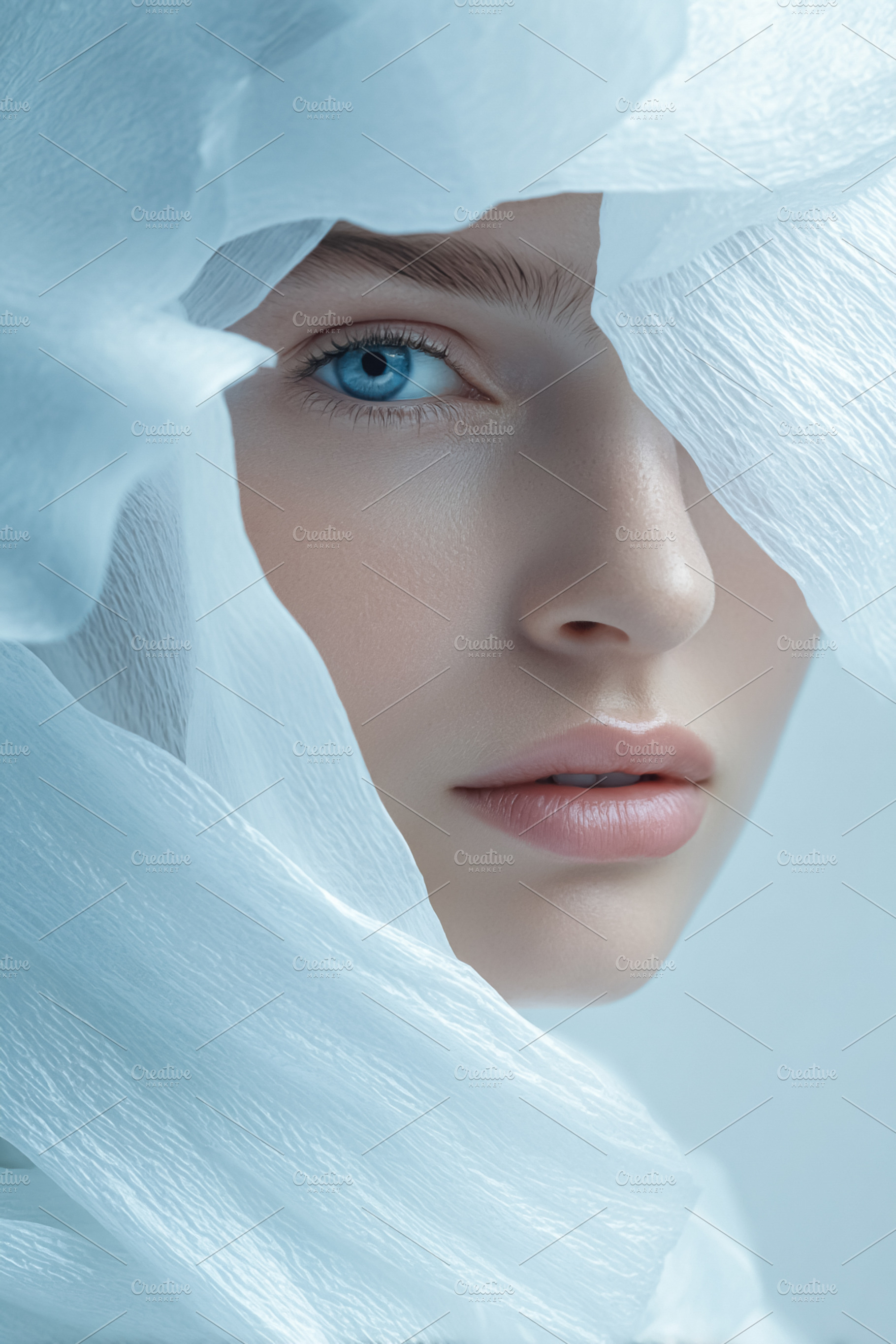 Woman's portrait with bright blue eye looking out from behind et, a Photo by Studio ANNA
