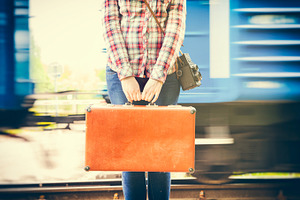 Girl with suitcase on platform