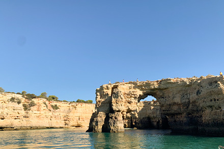 Coastal cliffs of Algarve with natural rock formations and turqu