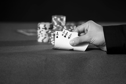 Close-up of hands with four aces in