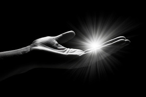 Hand holding light in darkness, a Photo by Beautiful things