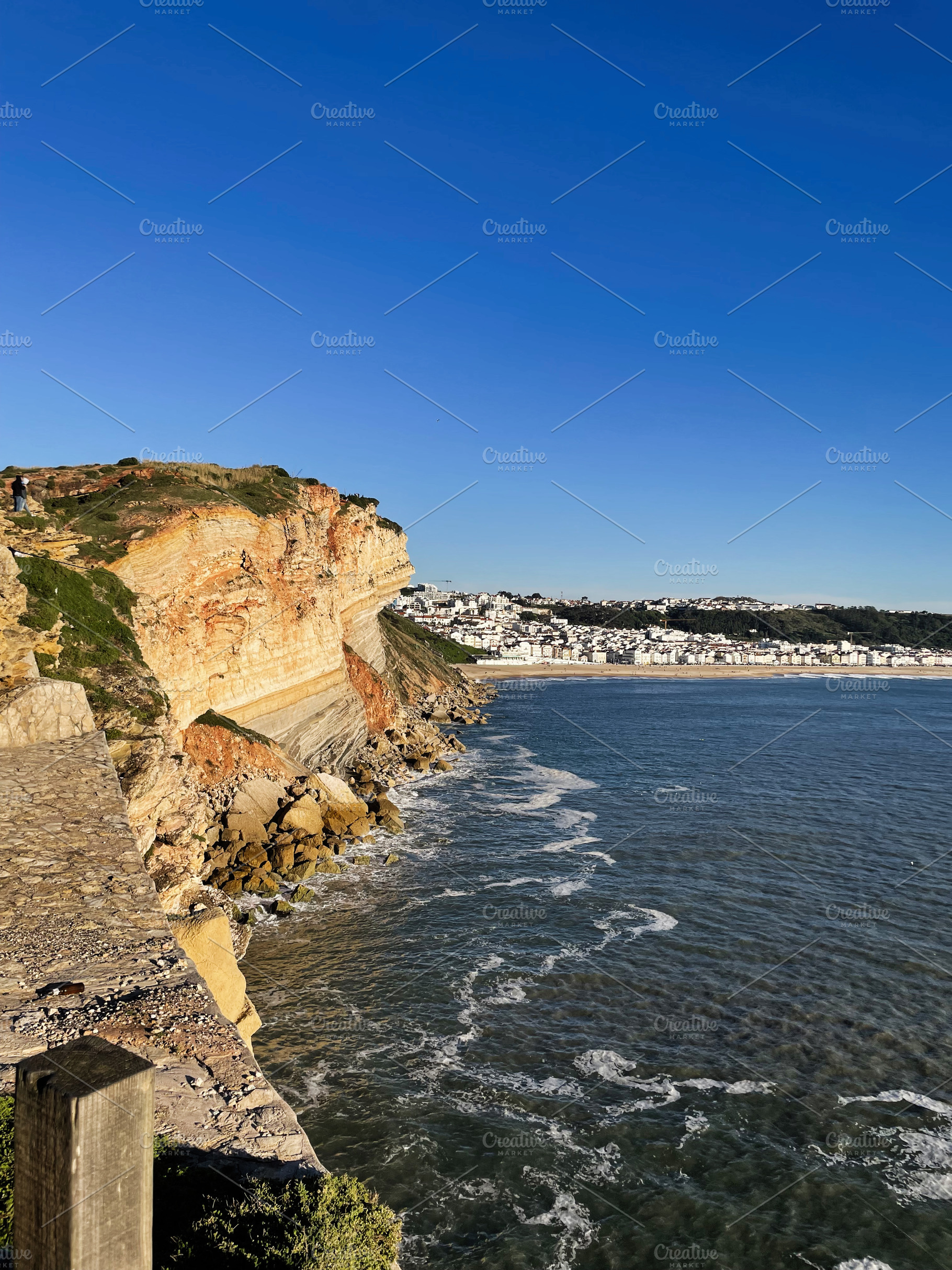 Scenic coastal cliffs and ocean in Nazare, Portugal under clear blue sky, a Photo by AS photostudio