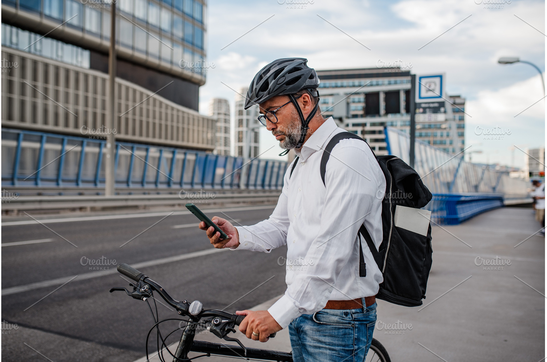 Manager on bike, reading text, a Person Photo by HalfPoint