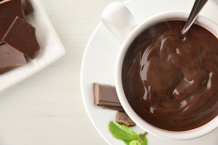 Hot chocolate detail in white ceramic cup on plate top, a Food & Drink Photo by Davizro's Market
