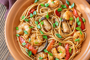 Asian stir fry udon noodles with prawns mushrooms vegetables in, a Food & Drink Photo by Alexander Prokopenko