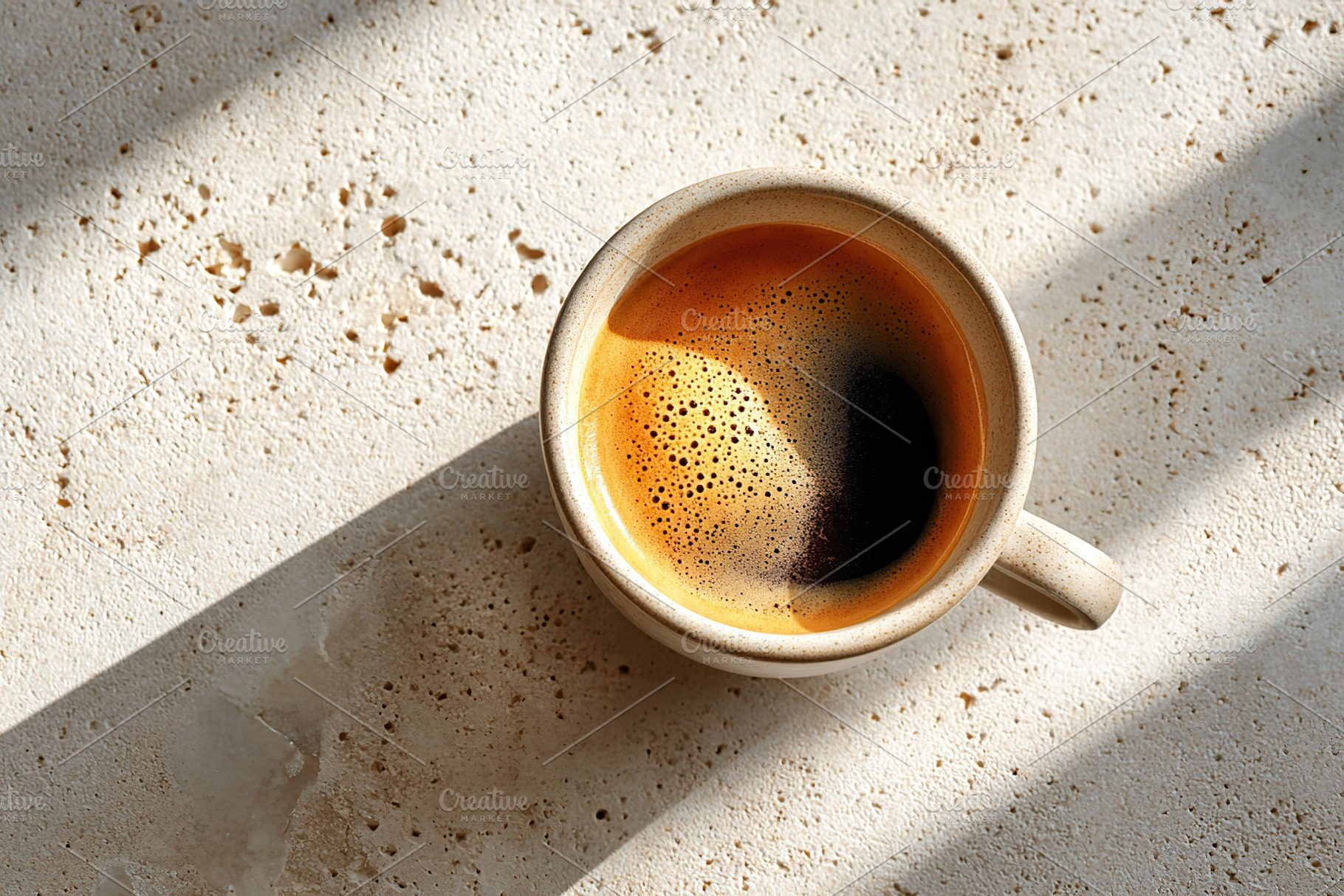 Overhead view of a single ceramic mug filled with coffee on a textured surface, a Food & Drink Photo by AlyaAnd