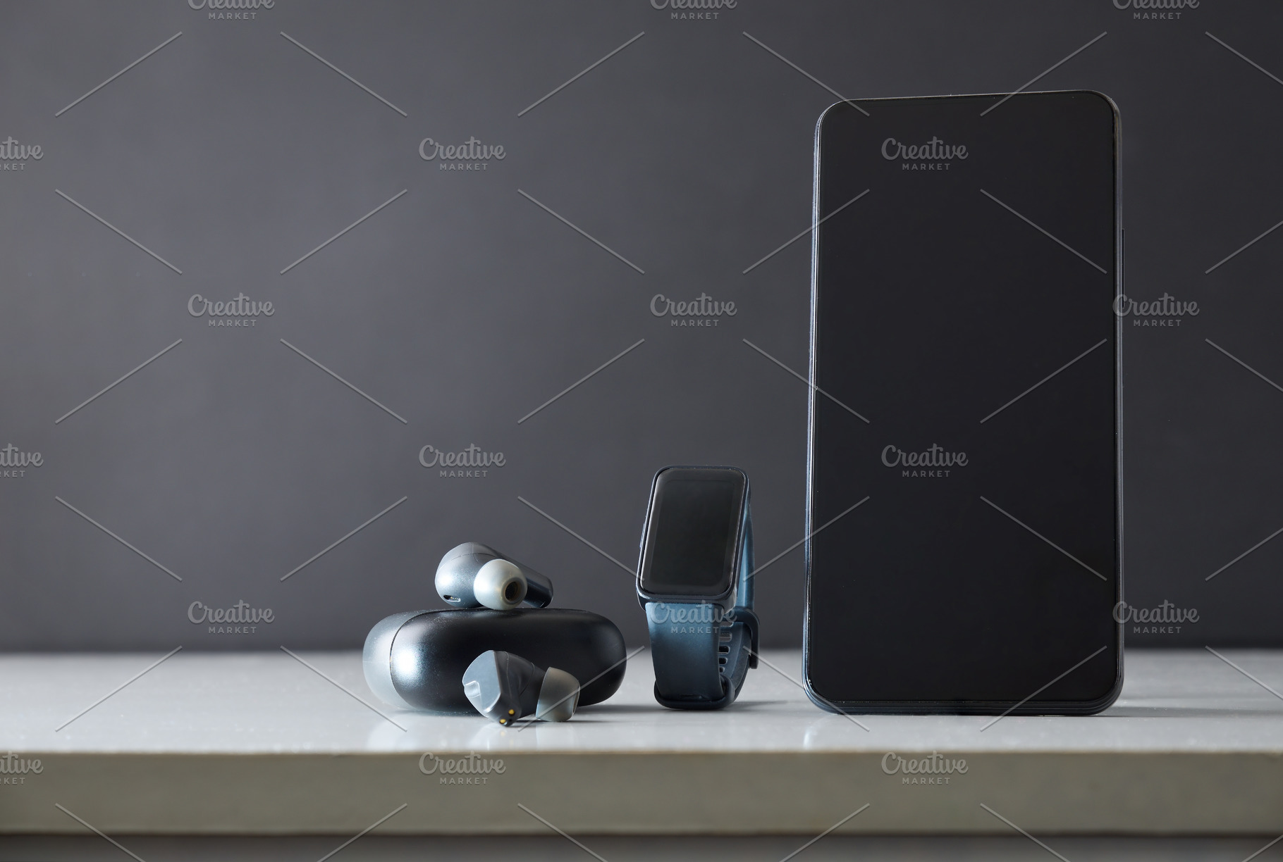 Smartphone smartwatch and headphones on white table isolated gra, a Sports & Recreation Photo by Davizro's Market