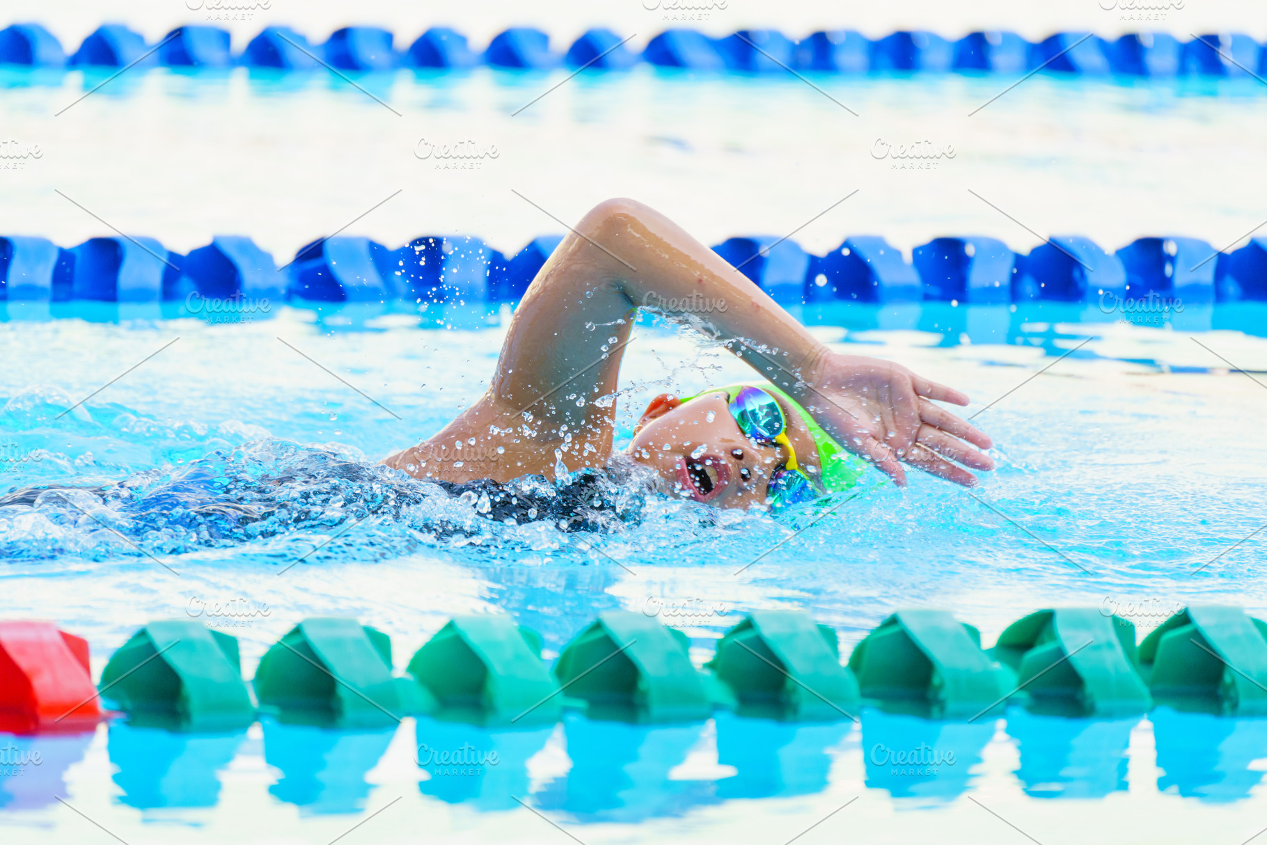 Swimmer child swims freestyle swimming style in a race swimming, a Sports & Recreation Photo by Casanowe-studio