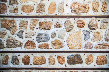 background of concrete gray wall with colored decorative stones, a Holiday Photo by TanaCh