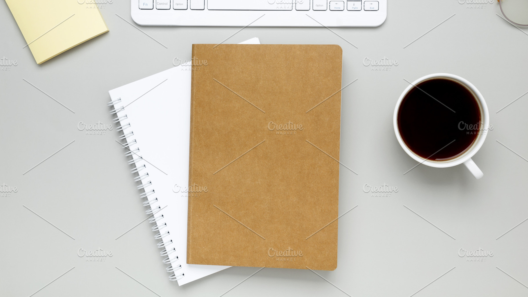 Simple desk arrangement with coffee cup, eyeglasses and notebook forming quiet, a Photo by matucha