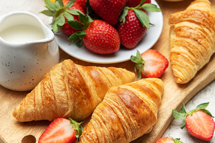 Delicious french breakfast with croissants, coffee, strawberries, a Food & Drink Photo by Olena Rudo