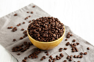 Organic Roasted Coffee Beans in a Bowl, side view., a Food & Drink Photo by LiudmylaChuhunova
