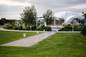 Modern outdoor venue with stylish architecture and a peaceful landscaped walkwa, a Photo by AS photostudio