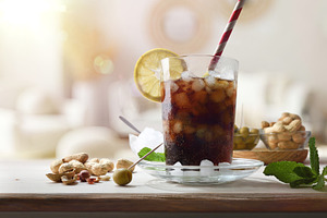 Refreshing cola drink on wooden table with snacks in room, a Food & Drink Photo by Davizro's Market