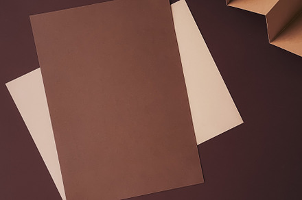 Beige and brown A4 papers as office stationery flatlay, luxury b, a Business Photo by Anneleven