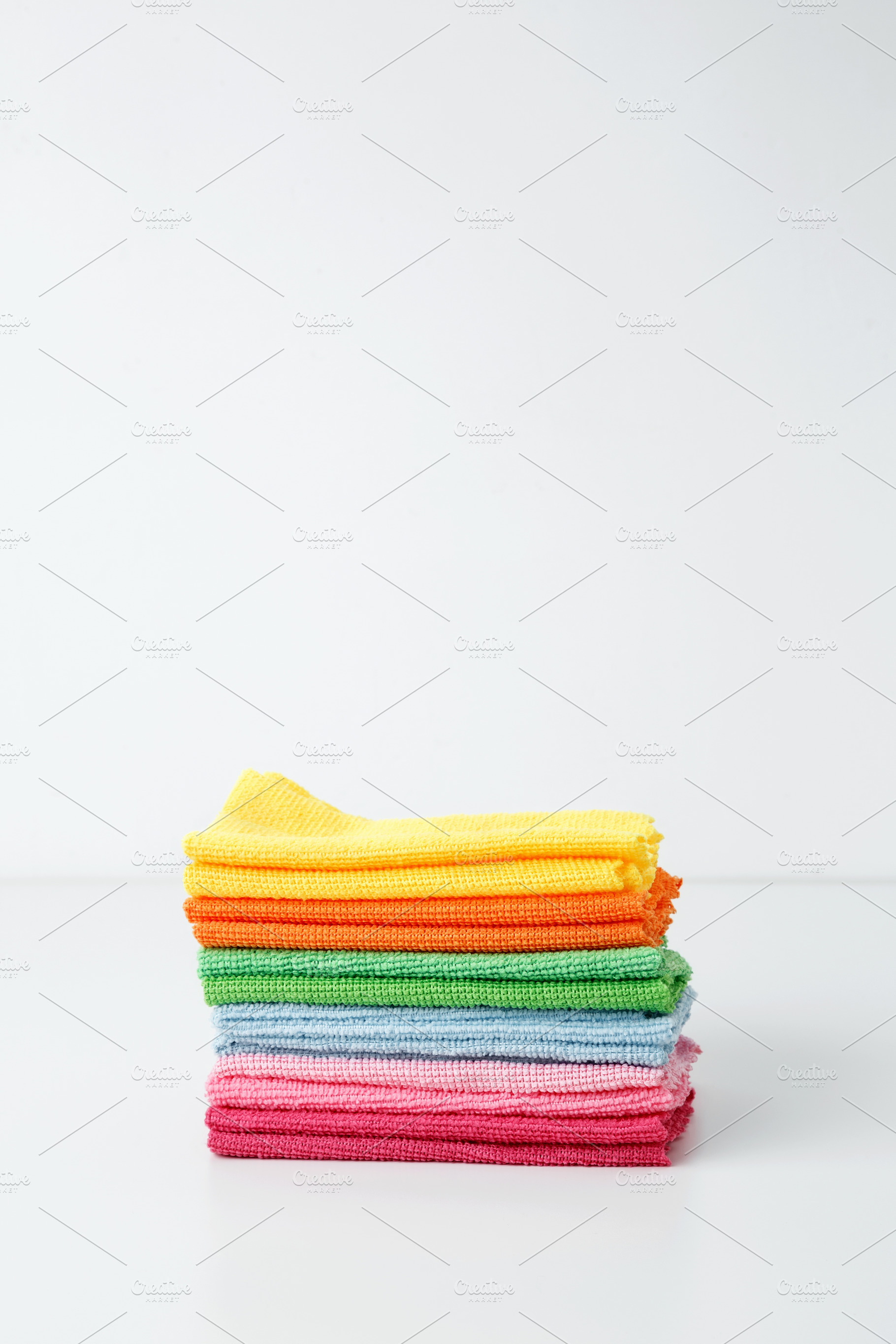 Colorful cleaning cloths neatly arranged, bringing brightness and energy to spr, a Photo by matucha