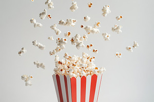 Popcorn flying with red white stripe, a Food & Drink Photo by Pixeness Studio