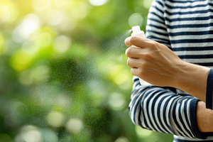 Person using a spray bottle outdoors, a Photo by Beautiful things