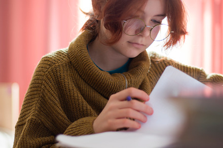 schoolgirl with glasses doing homework., a Photo by Pictures for you!!!!!!!!!