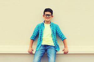 Happy smiling teenager boy in eyegla