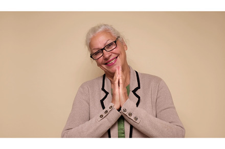 An elderly European woman is praying