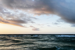 Sunset over calm Florida coast with waves under dramatic clouds in open sea at, a Nature Photo by AS photostudio