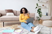 Young black wioman sitting on floor with study materials, having online class w, a Photo by Prostock-Studio (Thumbnail 1 of 2)