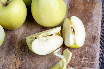 sliced and peeled green apple on a wooden board, a Food & Drink Photo by MyPhotos