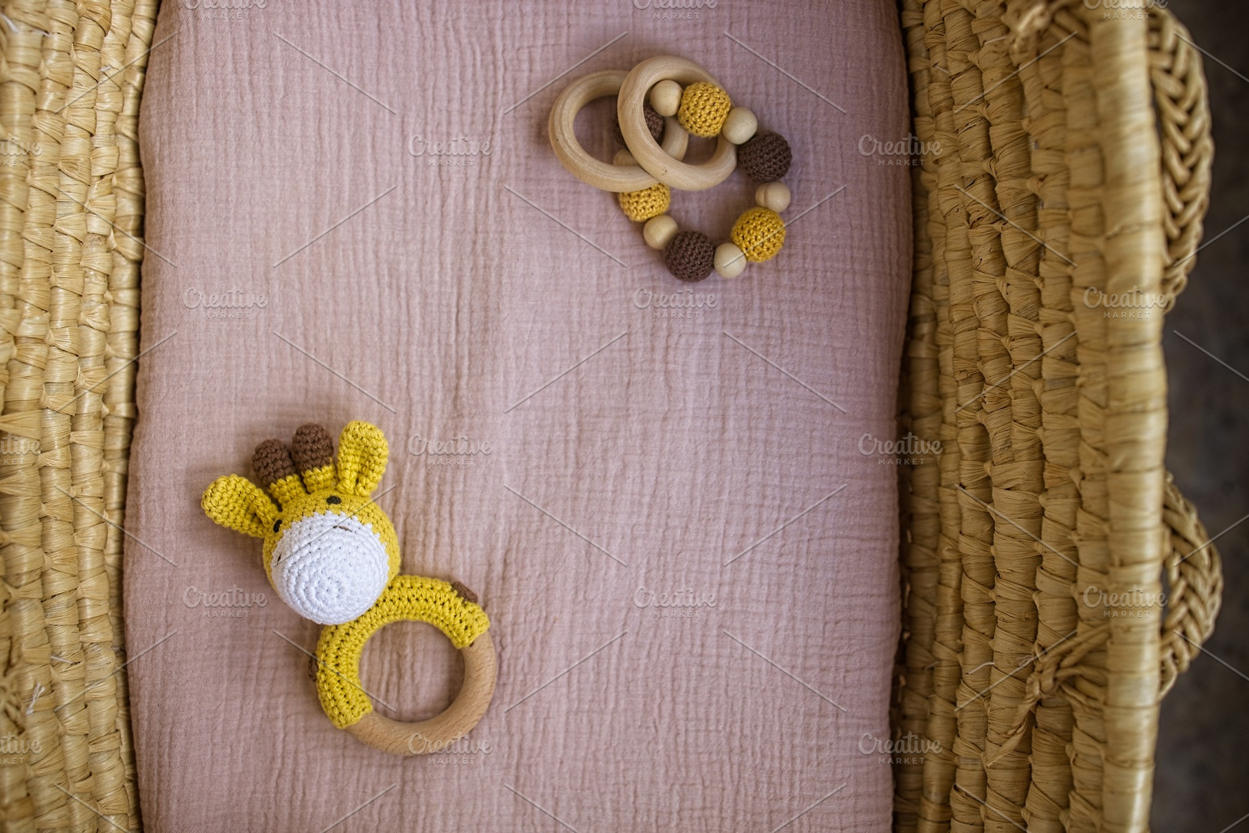 in a basket natural wooden knitted toys for a newborn. View from above, a Beauty & Fashion Photo by TanaCh