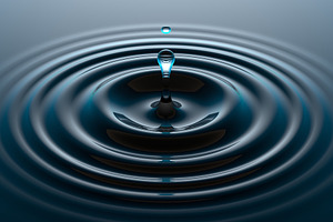 Water drop falling into water surfac