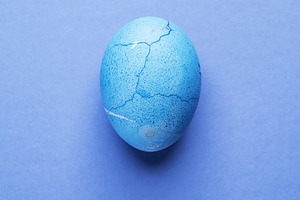 Stained in blue Easter egg on blue, a Photo by Volff