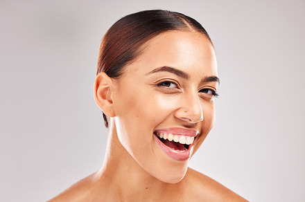 Black woman, smile and face portrait for beauty, health and cosmetic skin in studio for wellness. Woman, healthy skincare and makeup for model with happy radiant glow facial by cosmetics background, a Photo by Peopleimages.com