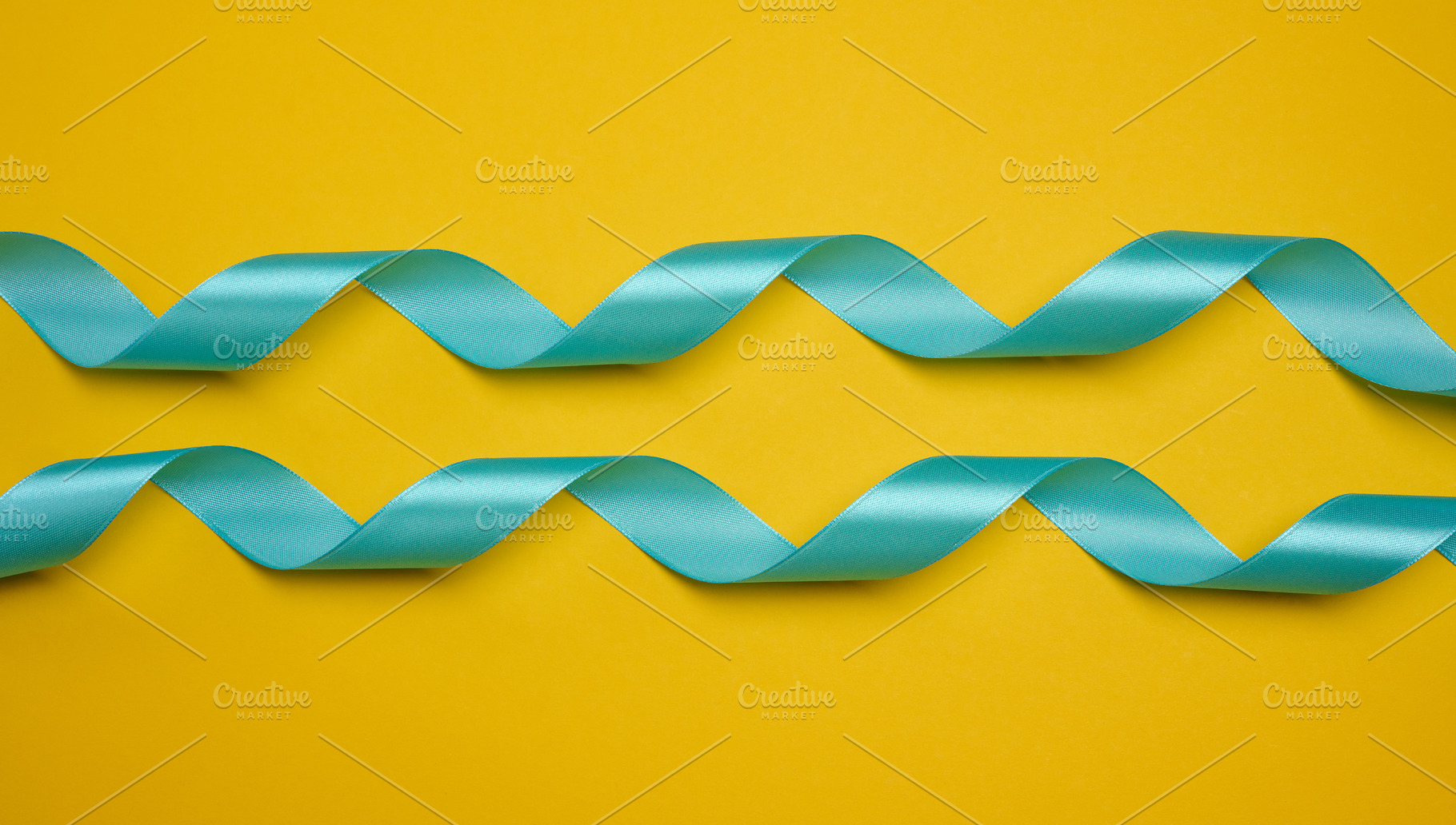 Blue satin ribbon, curved into a wave, centered on a yellow back, a Holiday Photo by ndanko