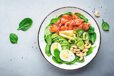 Keto salad bowl with salmon, avocado, spinach, cucumber, eggs, c, a Food & Drink Photo by 5PH