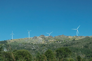 Wind turbines on green hills under blue sky, vila real, portugal, a Photo by DanFLCreativo