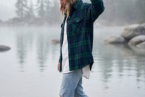 Woman walking barefoot on lakeshore, a Photo by Virgo Studio