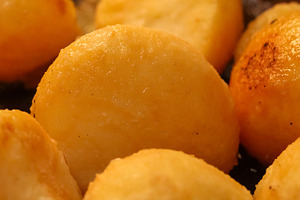 Crispy golden potatoes sizzling in hot oil, forming a delectable, a Photo by Studio ANNA