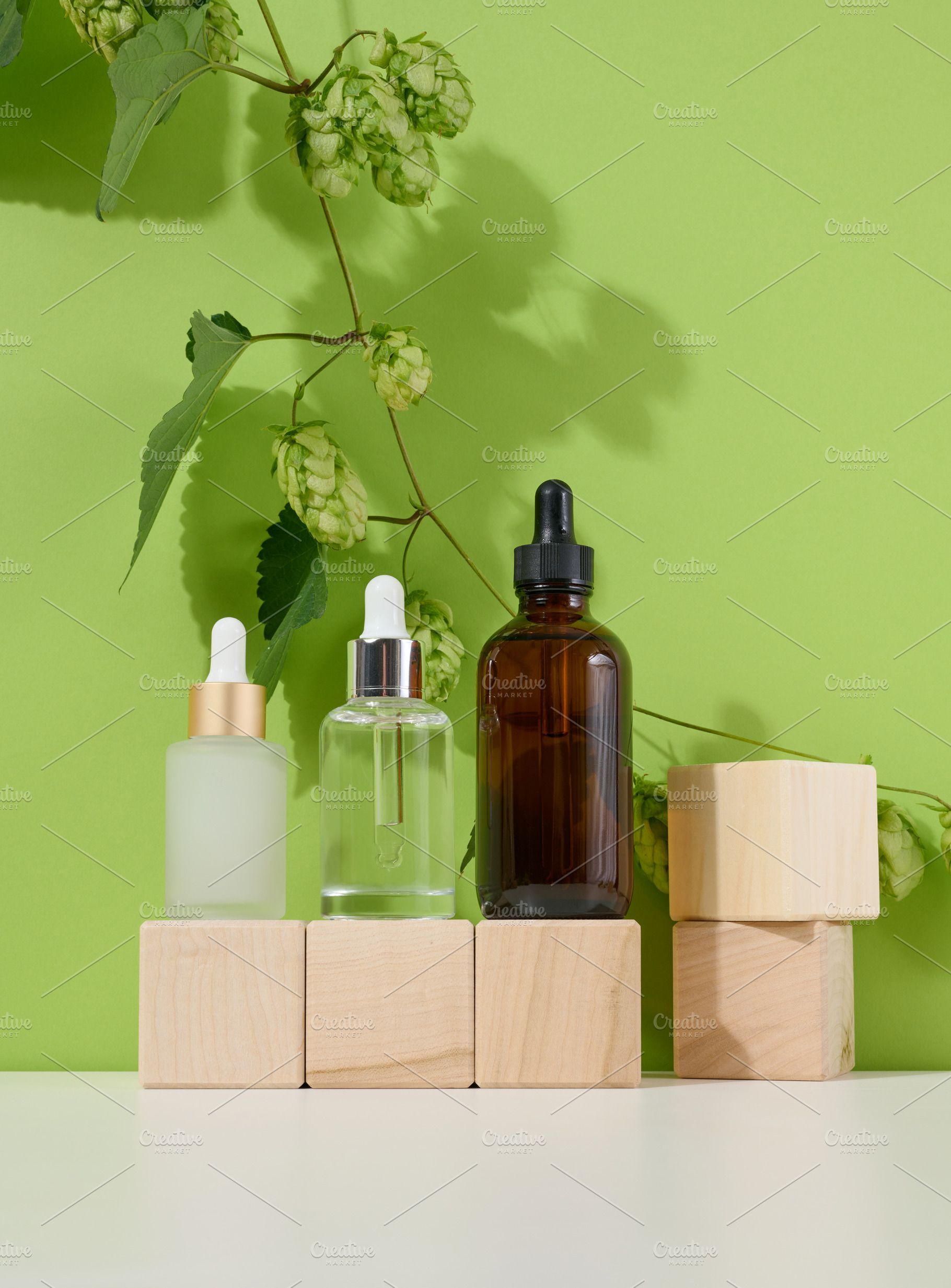 Three glass bottles with pipettes for cosmetics, acids, oils on, a Beauty & Fashion Photo by ndanko