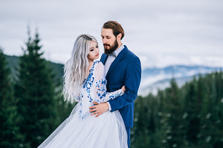 Groom in a blue suit and bride in wh featuring carpathians, against, and, a Person Photo by Weddings, People, Travel