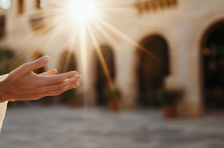 Hand of Jesus reaching out with light in spiritual scene, copy s, a Photo by Dvoevnore photos