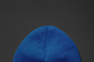 A blue knit beanie hat mockup on a dark background, a Hat Mockup by Textures & Backgrounds