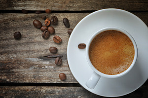 Espresso coffee cup containing coffee, coffee beans, and expresso