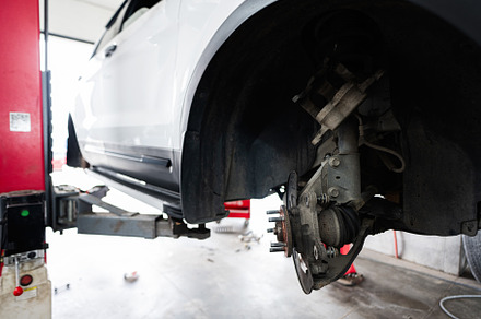 Car repair in progress at an auto workshop, a Transportation Photo by AS photostudio
