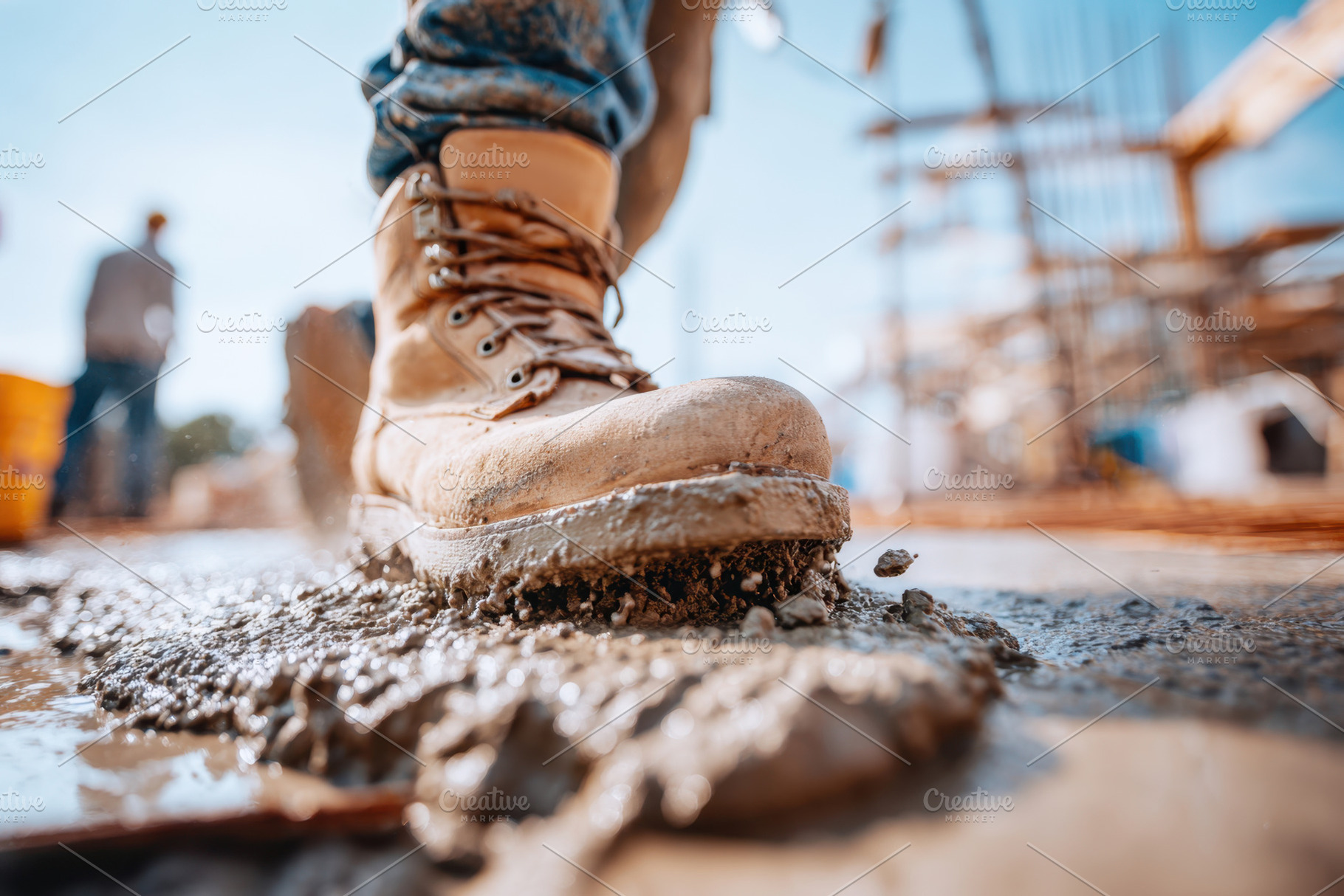 Close-up of work boot on wet concrete at construction site, an Industrial Photo by AlyaAnd