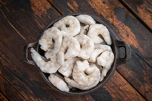 Frozen raw shrimp prawn on a dark rustic wooden background with, a Food & Drink Photo by composter-box@mail.ru
