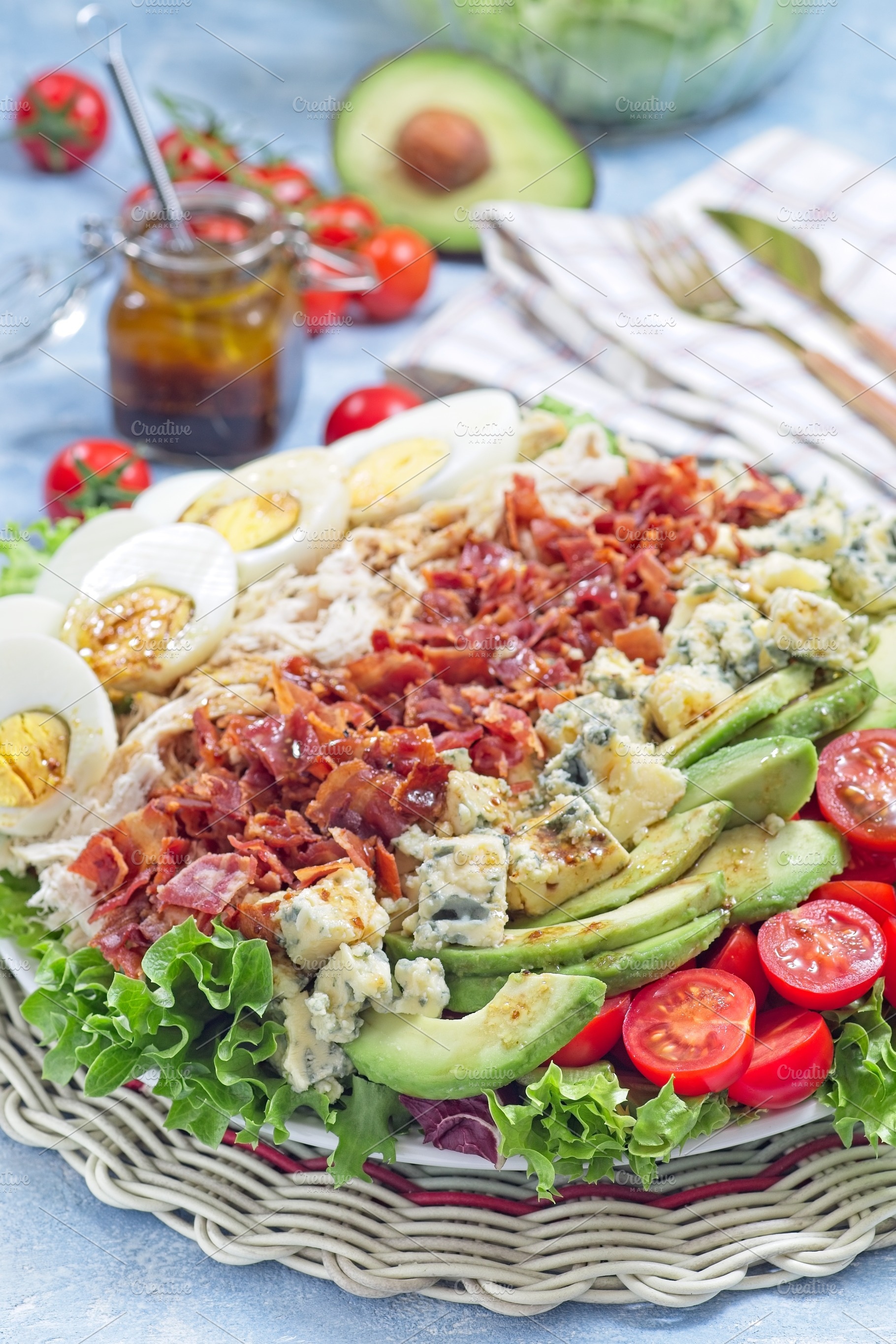 Delicious Cobb salad with greens, tomato, avocado, blue cheese, bacon, chicken, a Food & Drink Photo by iuliia_n
