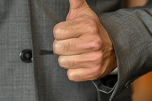 Businessman hand shows thumb up sign gesture, a Business Photo by AlyaAnd