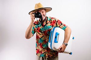 Smiling man ready for tropical vacation adventure, a Person Photo by karrastock